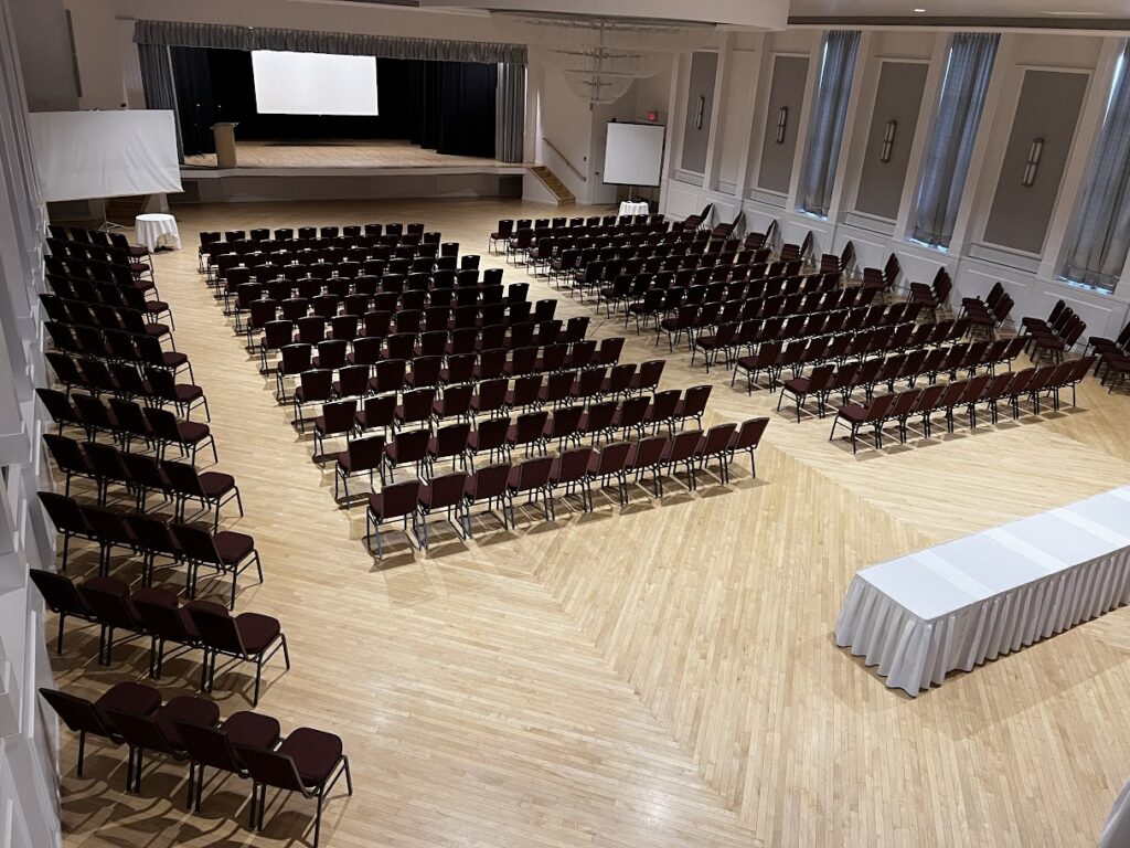 A view of the Ballroom set and ready for an event requiring a theatre style setup. There is seating for over 300 people in this image.